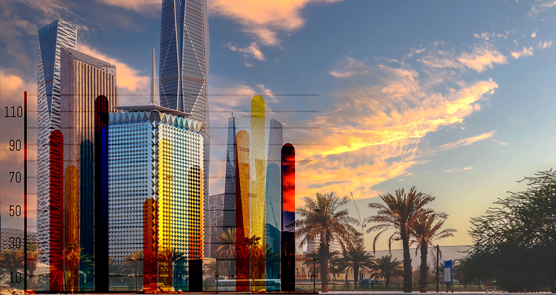 Skyline of skyscrapers with colorful facades against a sunset sky backdrop in Saudi Arabia.