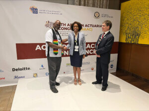 John Robinson transfers the Caribbean Actuarial Association's presidential medal from Kyle Rudden to Simone Brathwaite.