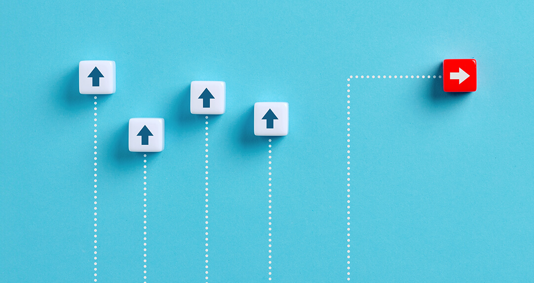 Four small white cubes with arrows pointing up and one red cube with an arrow pointing right sit on a cerulean blue background.