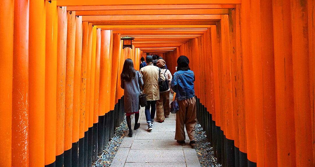 Visitors pass through a series of torii gates at the Fushimi Inari shrine in Kyoto, Japan.