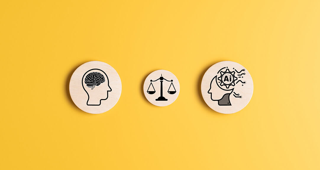 Three wooden disks on a yellow background have symbols denoting the human mind, balance and AI.