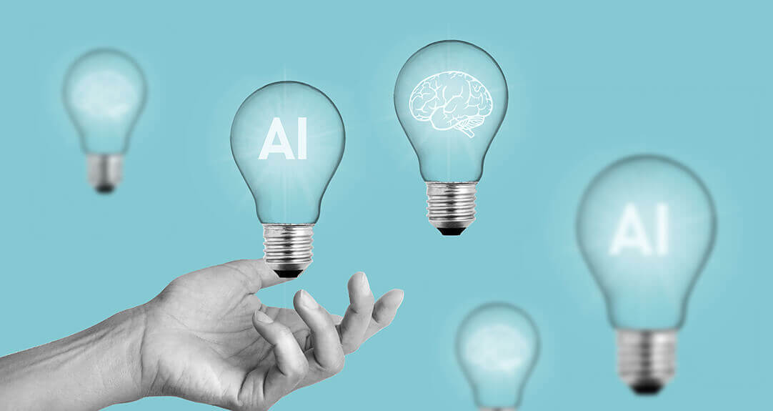 Clear light bulbs float in front of a blue background. Some feature drawings of a human brain, while others display the initials “AI.”