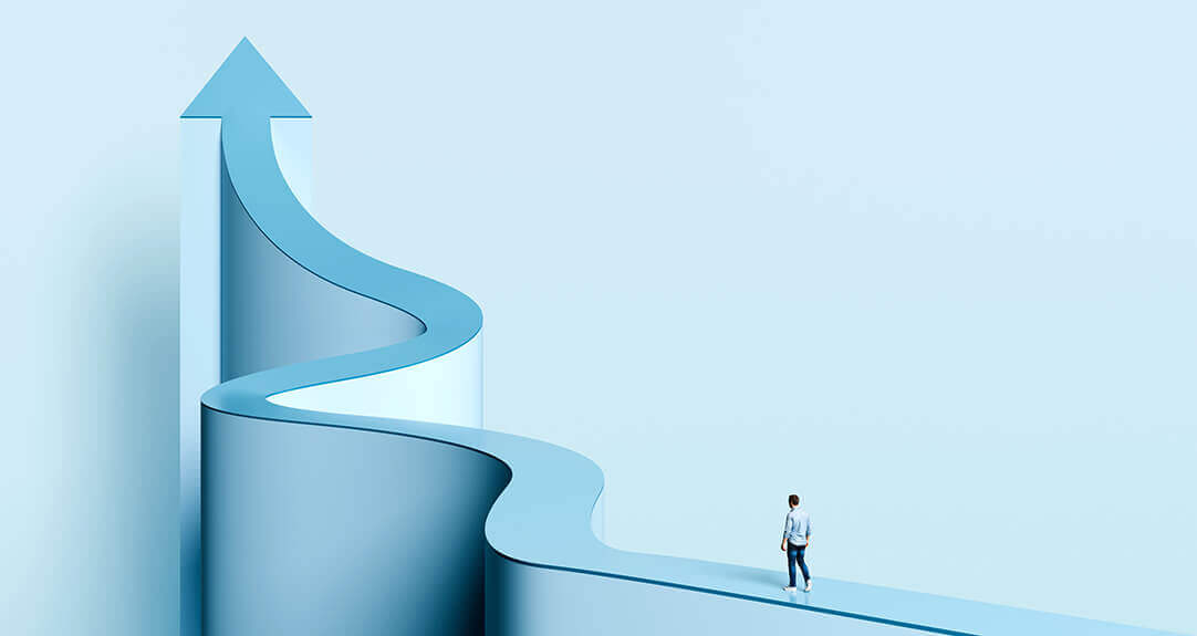 A man walks along a winding path that becomes an upward arrow.